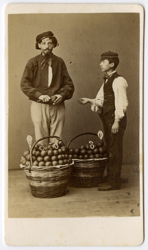 neurčený autor - Chlapec a muž u košů s pomeranči